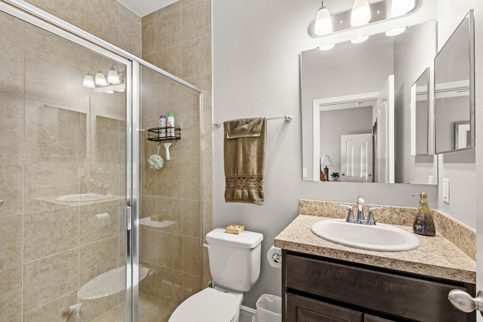 bathroom with brown sink cabinet